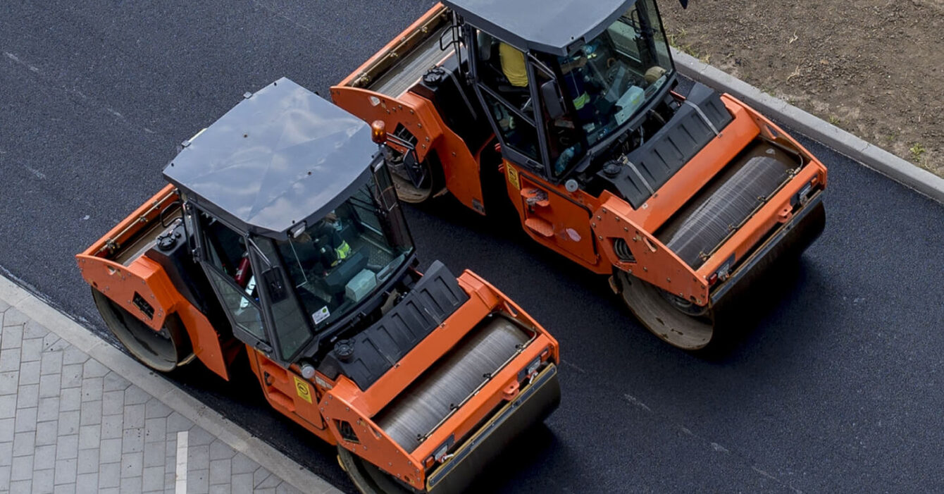 aerial-view-orange-vibratory-asphalt-roller-compactor-new-pavement (1) aerial-view-orange-vibratory-asphalt-roller-compactor-new-pavement (1)